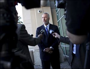 Clark County District Attorney Steve Wolfson, framed by reporters, speaks with media after a news conference releasing information about last week's deadly shooting and subsequent car crash on the Las Vegas Strip at Las Vegas police headquarters in Las Vegas.