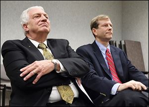 Lucas County Democratic Party chairman Ron Rothenbuhler, left, and Republican Party Chairman Jon Stainbrook, both members of the Lucas County Board of Elections, listen to the results of a state-ordered review of the board's procedures. 