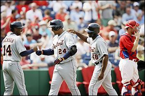 Detroit's Miguel Cabrera (24) celebrates with Austin Jackson (14) and Torii Hunter after hitting a three-run home run.