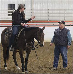 University of Findlay student Bekah Irish speaks with riding instructor Art O'Brien. At present, 184 students — 114 in western riding and 70 in English riding — are enrolled in the program at the Hancock County institution.