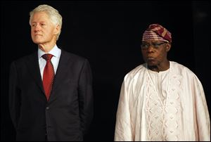 Former U.S. President Bill Clinton, left,  and former Nigeria President, Olusegun Obasanjo, right, attend the annual ThisDay awards ceremony, in Abeokuta, Nigeria.
