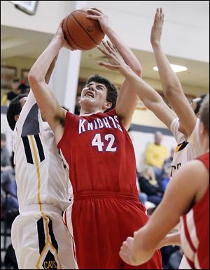 St. Francis’ Jay Snell, center, goes to the basket against Northview’s Aerin West on Tuesday. Snell scored all 10 of the Knights’ third-quarter points and posted a game-high 18 in their victory.