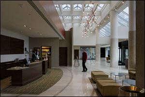 A valet crosses the lobby of the new Best Western Premier Hotel in downtown Toledo. The hotel was former the Grand Plaza Hotel.