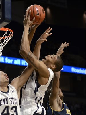 Penn State's Jermaine Marshall pulls down a rebound between teammate Ross Travis, left, and a Michigan defender during the first half today in State College, Pa.