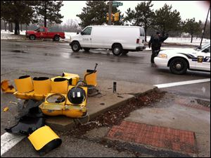 The wreckage of a traffic light rests on the ground on the Anthony Wayne trail near Woodsdale after an injury crash early today.