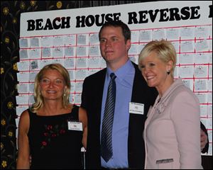 The Beach House Reverse Raffle co-chairmen Katrina Iott and Joe Rosenberg with event emcee Chrys Peterson of WTOL-TV, Channel 11.