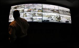 Toledo Police Chief Derrick Diggs views video camera feeds in the department's real-time crime center at the Toledo Safety Building.