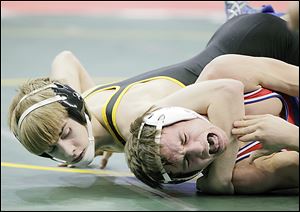 Clay's Richie Screptock, left, beat Alec Cotton of Uniontown Lake 5-0 in their 120-pound match Thursday in Columbus. 