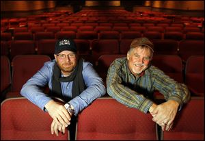 Jason Hamilton, left, and Mike Malone at the Maumee Indoor Theater, where their documentary about Toledo singer/songwriters called 