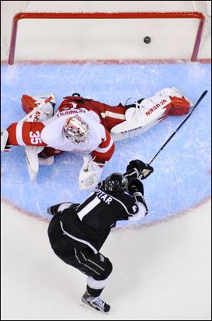 Los Angeles Kings center Anze Kopitar, below, scores on Detroit Red Wings goalie Jimmy Howard during the third period.