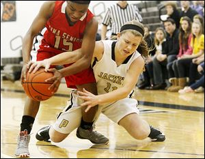 Perrysburg's Mollie Whitacre goes in for a steal of the ball from Lima Senior’s Indiya Benjamin during the first half of Thursday’s Division I district semifinal. The Yellow Jackets won, 79-64.