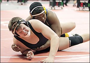 Whitmer’s Marquise Moore, top, records the winning takedown in to defeat Massillon Perry’s  Stefano Millin 3-1 in overtime in a 285-pound match Thursday.