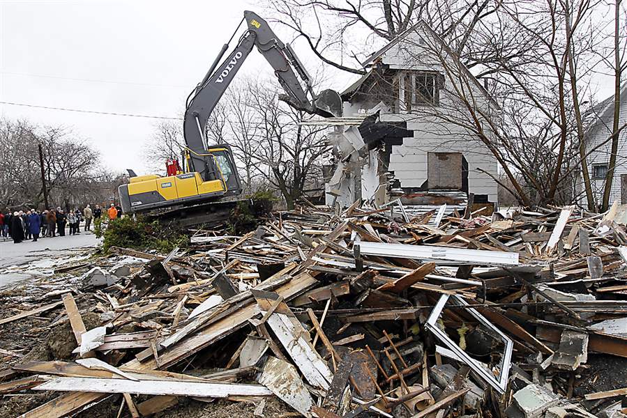 Workers-demolishing-home