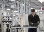 Jordan Kenyon works on the assembly line during a media tour before an investment and jobs announcement event at the Chrysler transmission plant in Kokomo, Ind.