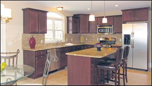 Gourmet kitchen with plenty of counterspace, a large work island with snack bar, and a generous pantry.