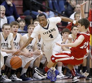 Anthony Glover of St. John's knocks over  Kevin Metzger of St. Francis. The Titans improved to 20-3.