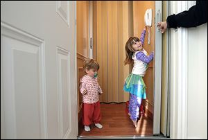 Aden Enzer, 5, right, and her little sister Bennett, 2, use their elevator at home in Los Angeles. Families juggling children, pets and groceries are among those who are adding home elevators.