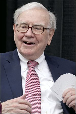In this May file photo, Warren Buffett, chairman and CEO of Berkshire Hathaway, plays bridge during the annual shareholders meeting in Omaha, Neb.