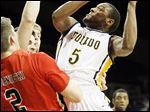 Toledo guard Rian Pearson drives the lane under pressure from multiple Ball State defenders during the first half of Saturday's home game. Pearson scored 20 points.