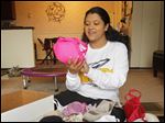  UT grad student Natasha Smet sorts and packs bras in her Toledo apartment for the Free the Girls program.
