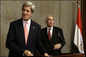U.S. Secretary of State John Kerry, left, and Egyptian Foreign Minister Mohammed Kamel Amr leave after a news conference today in Cairo.