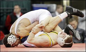 Archbold’s Logan Day finds himself in trouble against J.J. Diven of Atwater Waterloo in the 138 final.