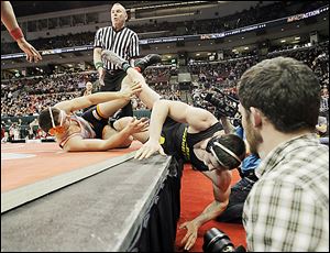North Baltimore’s Dalton Ismael, left, rolls Tyler Beck of Galion Northmor off the mat during their Division III 195-pound championship match at the Schottenstein Center. Beck won in OT.