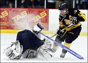 Northview's Zander Pryor moves the puck and collides with  St. John's goalie Mike Barrett during a district championship hockey game. Pryor scored the tying and go-ahead goals for the Wildcats.