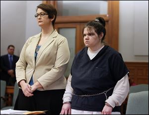 Jennelle McGuire, 20, of Oregon, right, with attorney Gretchen DeBacker, is sentenced in Lucas County Common Pleas Court for the fatal stabbing of her husband.