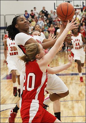 Rogers' junior Tatyana Reynolds goes in for a layup over Port Clinton freshman Marissa Day during the second half.