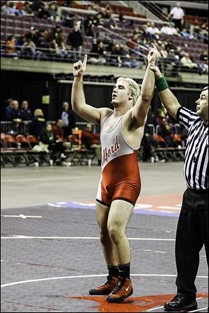Bedford's Brandon Sunday raises his arms after winning the 215-pound Michigan Division 1 state wrestling title. He defeated Westland John Glenn's Jordan Brandon 5-4 in overtime.
