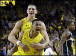  Michigan point guard Trey Burke, front, and forward Mitch McGary celebrate their 58-57 win over Michigan State today Ann Arbor. Trey Burke stole the ball from Keith Appling near midcourt and went in alone for a dunk with 22 seconds remaining, then made another steal in the final seconds to secure the win.