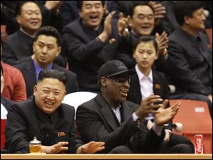 North Korean leader Kim Jong Un, left, and former NBA star Dennis Rodman watch North Korean and U.S. players in an exhibition basketball game at an arena in Pyongyang, North Korea, Thursday.