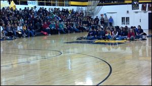 Students gather in the gym for Sunday's closing ceremonies. On the floor is the cast and crew of 