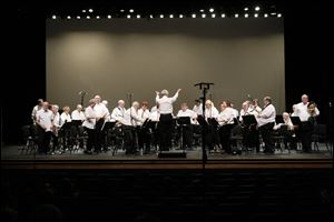 Director Fred Dais conducts the Owens Community College Band on Sunday afternoon during the Winter Pops at the Fine Arts Center on the college's Perrysburg Township campus. The band featured several guest performers, selections ranging from 