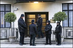 British police officers guard the King Edward VII Hospital in London. Queen Elizabeth II was admitted on Sunday, the first time in a decade she has been hospitalized.