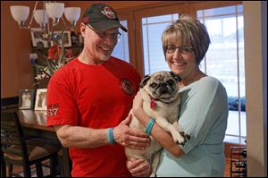 Ken and Debbie Balogh care for two special-needs dogs. Mugsy, a 9-year-old pug, is blind and needs twice daily shots for diabetes. Their golden retriever, Hayes, 14, needs help getting outside.