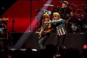 Jon Bon Jovi, right, performs with Richie Sambora at the MGM Grand Arena in Las Vegas. Bon Jovi is going on tour again. This new tour, dubbed Because We Can, after the first single from the new record, will travel the globe through at least July.