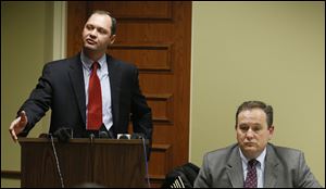 Attorneys Alan W. Mortensen, right, and  Dustin Lance, left,  speak during a press conference about the Clyde cancer cluster in 2012, at the Clyde Public Library in Clyde, Ohio.