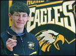  Erie Mason sophomore Logan Griffin holds the medal he won after taking the 112-pound state championship in Division 4. He won the final against Carson City Crystal’s Kenneth Dittenber 5-4 in three overtimes.