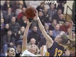  Perryburg’s Abby Sattler has a shot blocked by by Notre Dame’s Christy Ohlinger during their game Tuesday night. Notre Dame won and advanced to its second straight regional final.