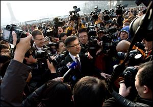 U.S. Ambassador to China Gary Locke, center, is mobbed by journalists as he attends the opening session of the annual National People's Congress at the Great Hall of the People in Beijing Tuesday.