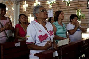 Supporters of Venezuela's President Hugo Chavez pray for the ailing president at the military hospital's chapel in Caracas.