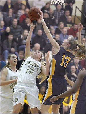 Perryburg’s Abby Sattler has a shot blocked by by Notre Dame’s Christy Ohlinger during their game Tuesday night. Notre Dame won and advanced to its second straight regional final.