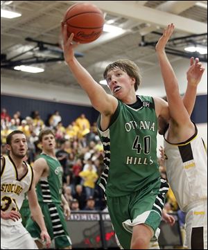 Ottawa Hills' RJ Coil (40) pulls in a rebound against Old Fort. The junior finished with 13 points and 13 rebounds in an OT win.
