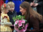  Britain's Catherine, Duchess of Cambridge receives flowers from 3-year old Isobelle Laursen, left, during her visit to Humberside Fire and Rescue Station in Grimsby, north Engalnd, Tuesday. 