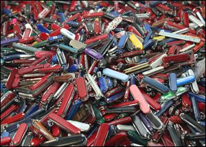 Knives of all sizes and types are piled in a box at the State of Georgia Surplus Property Division store in Tucker, Ga., and are just a few of the hundreds of items discarded at the security checkpoints of Hartsfield-Jackson Atlanta International Airport.