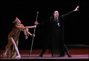Russian dancer Pavel Dmitrichenko, as Ivan the Terrible, right, performs at a dress rehearsal of 'Ivan the Terrible' in the Bolshoi Theater in Moscow, Russia. 