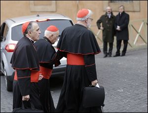 Cardinal Daniel Nicholas DiNardo, left, and Cardinal Sean Patrick O'Malley, right, arrive for a meeting, at the Vatican, today.