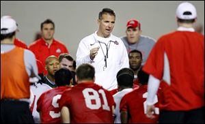 Coach Urban Meyer talks to the team during the first Ohio State football spring practice.